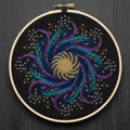 Galactic Mandala nebula-themed cross stitch pattern in hoop